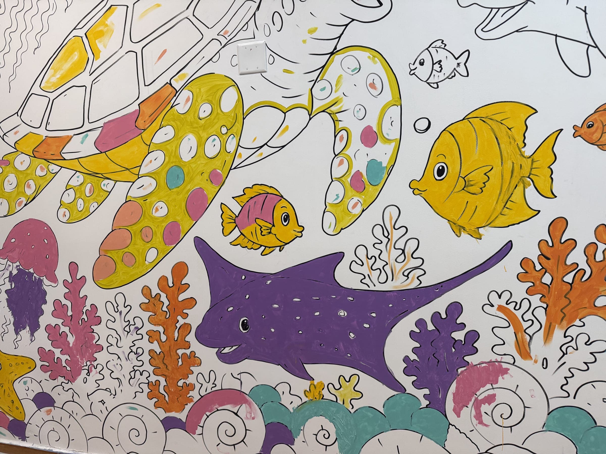 The reef wall mid-ParticiPAINTING: children's colour inside the outlines