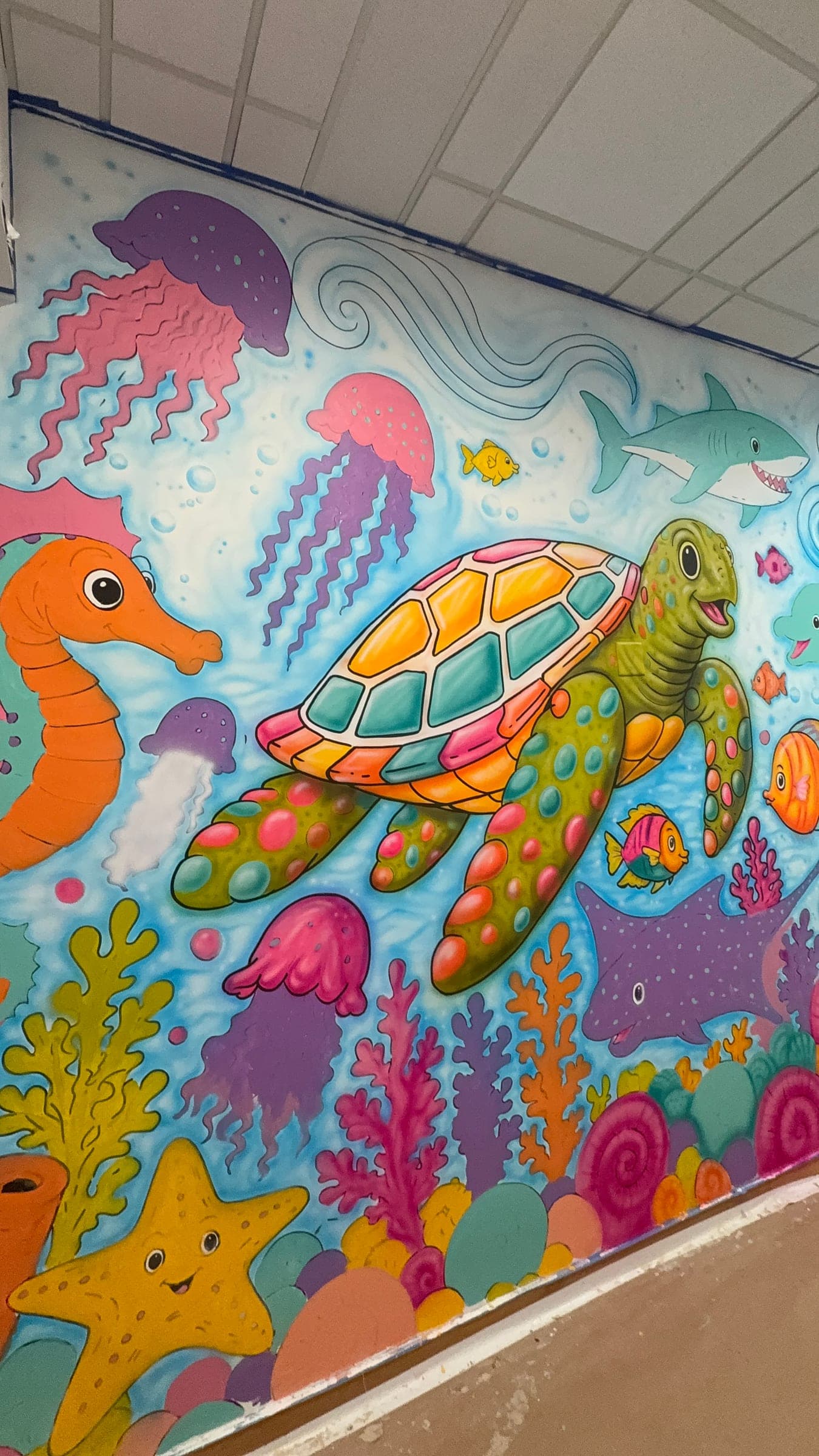 The same wall after professional finishing: the completed turtle